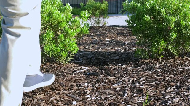 Unsuspecting man finds lost USB thumb drive on ground illustrating malicious USB drop attack - Cybersecurity Information Technology Concept