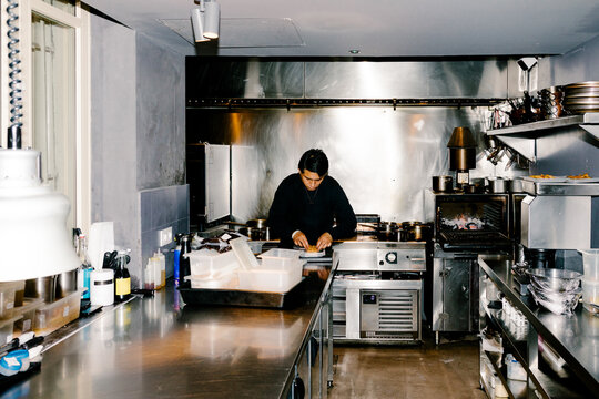 A chef at a specialty restaurant preparing a dish