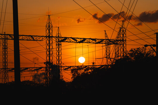 Geothermal energy power lines silhouetted against miravalles sunset