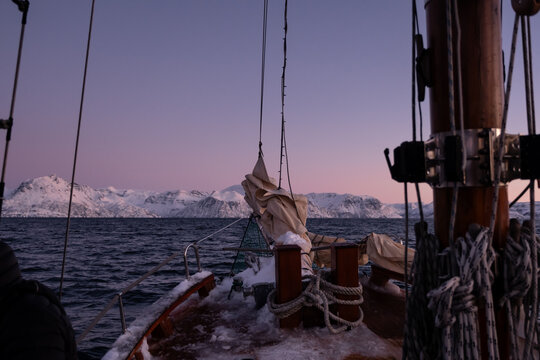 Purple sunrise hues on a sailboat in the Arctic circle, Norway