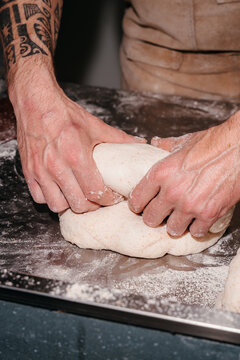 Hands Kneading Dough on a Kitchen Countertop