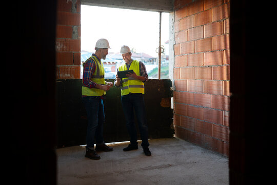 Workers plan at a sunny construction site