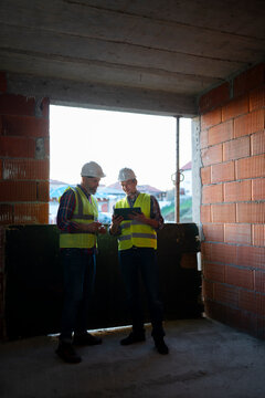 Builders discuss plans on-site