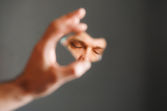 Holding a Reflective Surface to Capture a Face in Focus