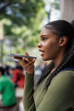 Woman dictating email while out in the city