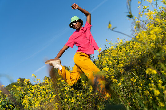 Happy man dancing field spring