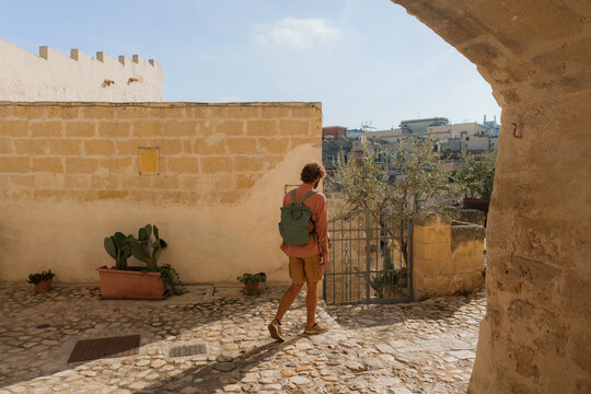 Man walking in Sassi di Matera in Puglia, Italy 