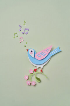 Paper spring craft bird on blossom with music