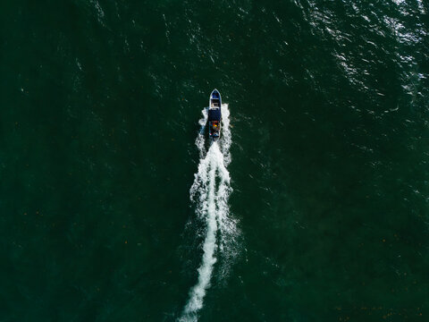 Speedboat moving in the sea leaving white wake