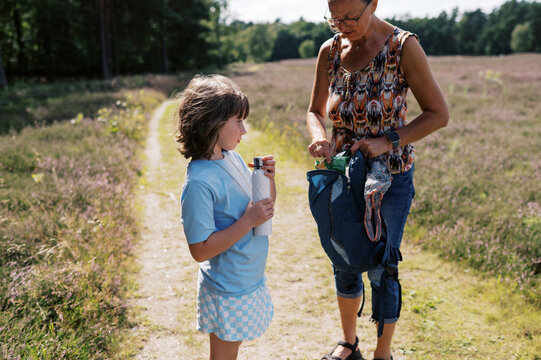 grandmother and granddaughter on hike together in heather in germany