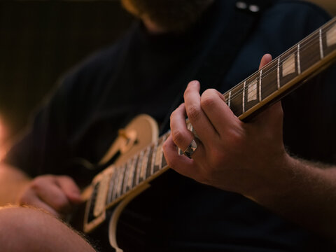 Music Creation With a Guitar in a Cozy Studio at Night