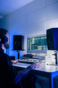 Artist making electronic music at home studio 