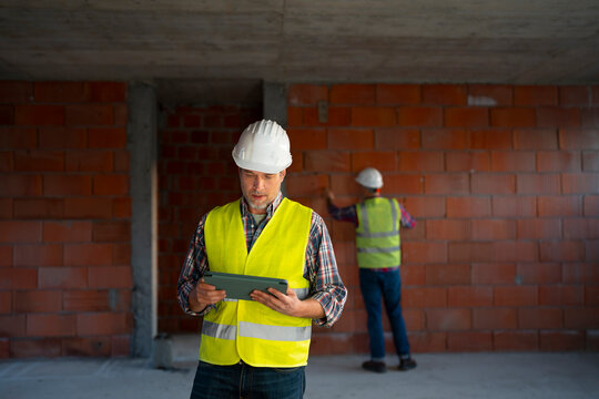 Workers on-site reviewing plans