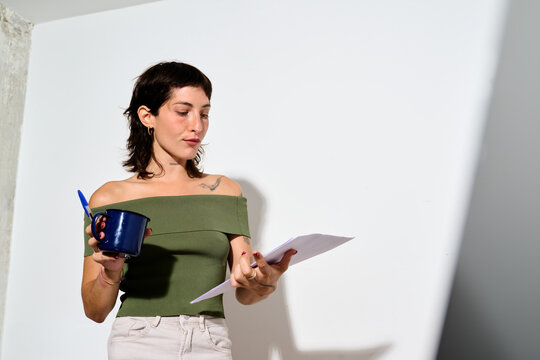 Woman Holding Papers and Cup During video call