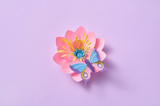 Paper spring craft butterfly on pink blossom