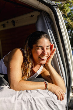 Portrait of woman making funny face in camper van in Australia