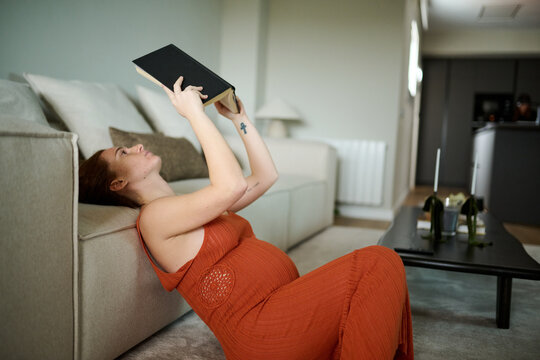 Pregnant Woman Reading a Book Indoors