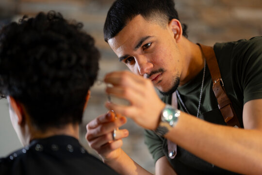 Barber cuts hair in salon