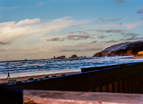 Beach View with Person Walking Near Waves Captured on 35mm