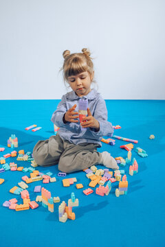 toddler playing with building blocks .