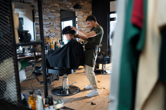 Haircut session in a busy barber shop with stylist