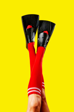 the raised legs of a man in red socks wear diving fins