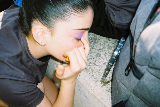 Gymnast Applying Makeup Before Competition 