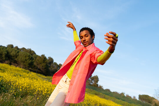 Dancer Performs in a Field With Bright Flowers in the Afternoon Sun