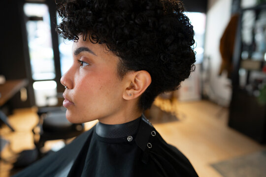 Curly-haired woman waits for haircut