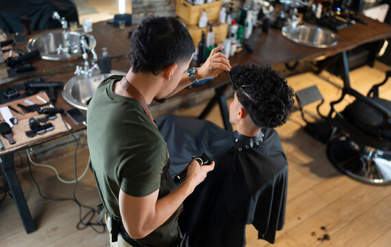 Haircut session in a busy barbershop with clients