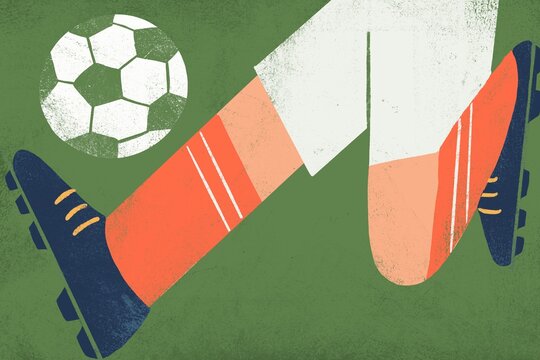 Football player&rsquo;s legs kicking the ball