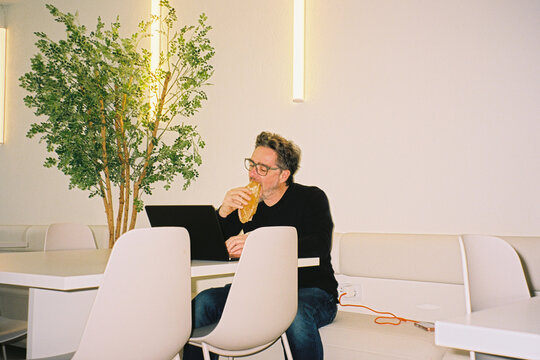 Man Eating While Working