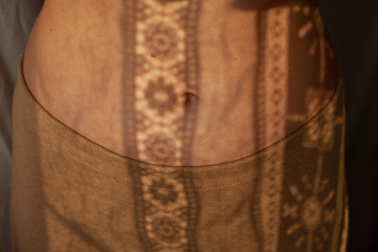 A female belly in the sunlight