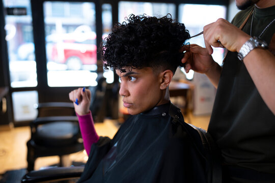Hairstyle change in a busy barbershop setting