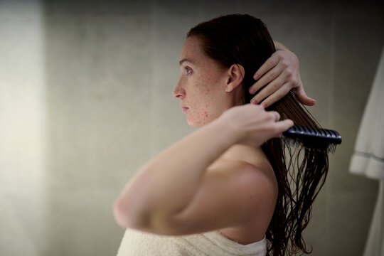 Pregnant Woman Brushing Hair
