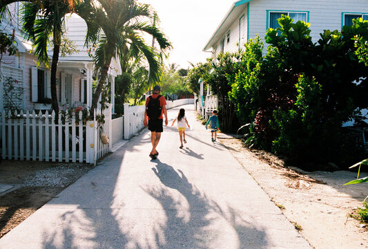 Family walks through Hope Town Settlement, Elbow Cay, Bahamas