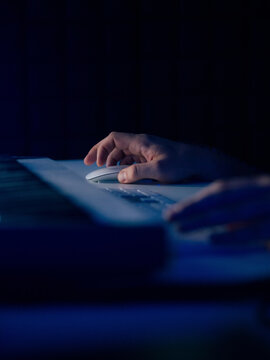 Man using computer mouse in the night 