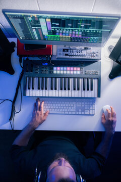 Music Production in a Studio With a Computer and Keyboard Setup