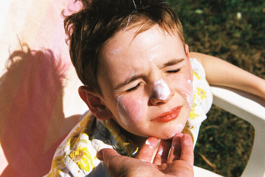 Film portrait of child with sunscreen on his nose