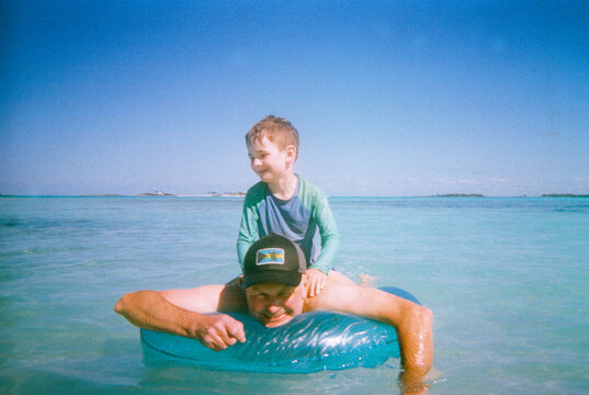 Candid family vacation moment swimming at beach