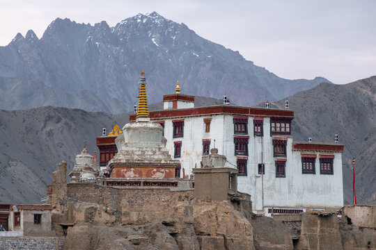 Buddhist monastery and stupa beneath mountain peaks in Ladakh
