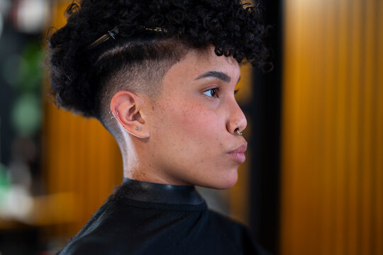 Woman getting a haircut at a barber shop