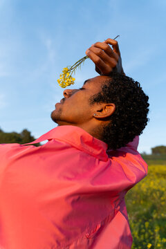 Dancer Performs in a Field With Bright Flowers in the Afternoon Sun