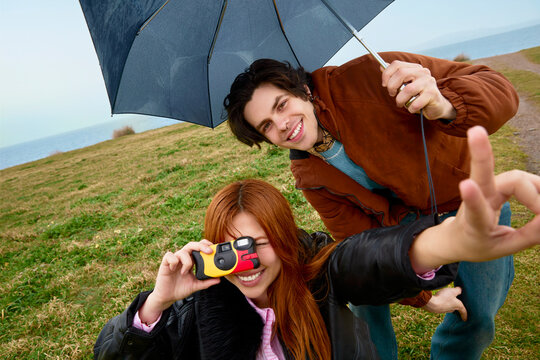 Woman taking photo with compact camera outdoors Galicia Spain