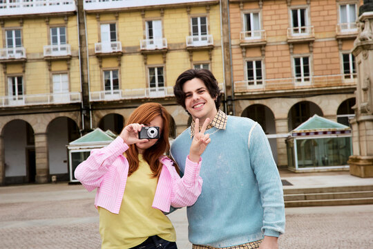 Couple posing with camera in historic square Galicia Spain
