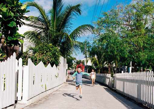 Family walking down the streets of Hope Town in Elbow Cay, Bahamas