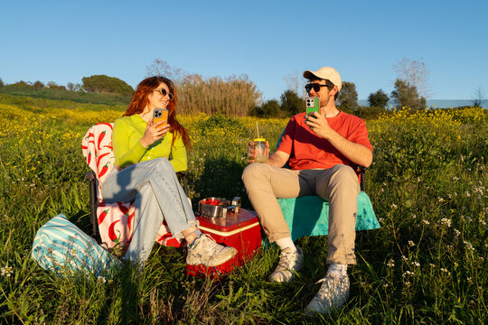Friends Enjoy Picnic on a Sunny Day in a Green Field 