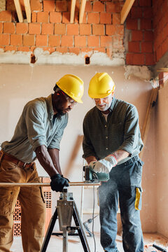 Construction Workers with Circular Saw