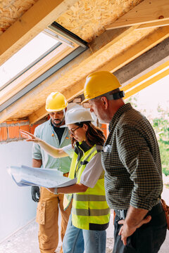 Construction Workers Brainstorming with Architect
