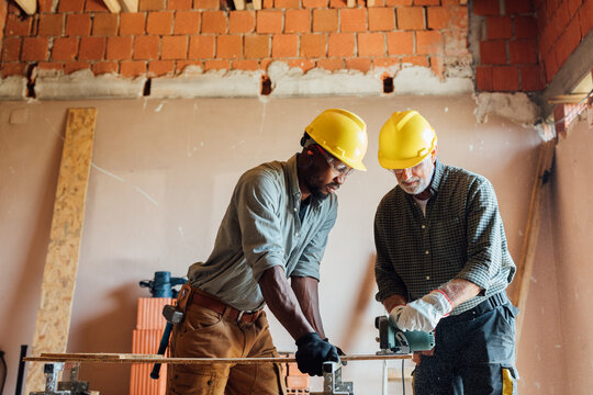 Construction Workers using Circular Saw 